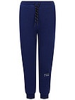 Синие спортивные брюки с объемными буквами - 4244519286234